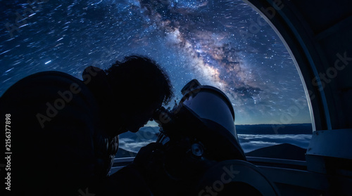 Silhouette of Astronomer Observing Milky Way Through Telescope at Night