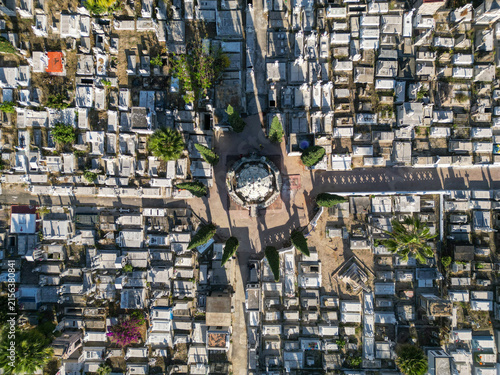 Aerial drone view of Mezquitan Cemetery, Guadalajara, Mexico. Rows of ancient tombs and pathways visible. Sunny day, cultural site.