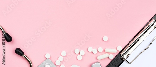 Stethoscope and Pills on Pink Background with Copy Space