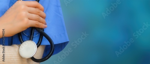 Doctor in Blue Scrubs Holding Stethoscope on Blue Gradient Background