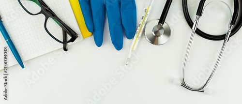 Medical Flat Lay with Stethoscope, Gloves, Thermometer and Notebook