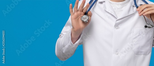 Doctor in White Coat Holding Stethoscope on Blue Background