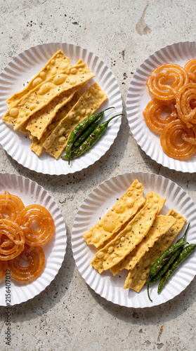 Photography Traditional Gujarati Fafda and Jalebi on Paper Plates with Fried Green Chilies