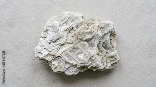 Close up of a light green mica mineral rock specimen.