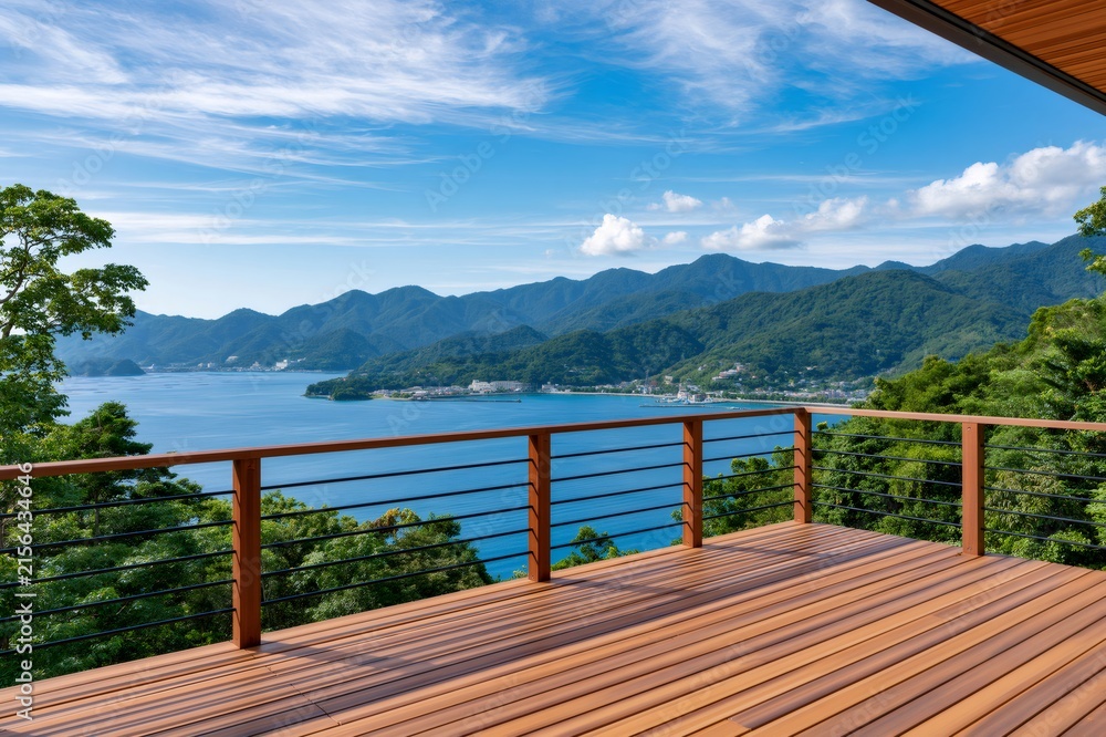Fototapeta premium Wooden deck overlooking tranquil bay and green mountains