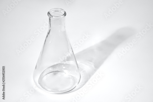 glass laboratory flask on a white table, chemistry or biology lesson