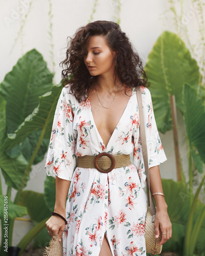 Obraz na płótnie Young Woman Floral Dress Tropical Leaves Background Fashion