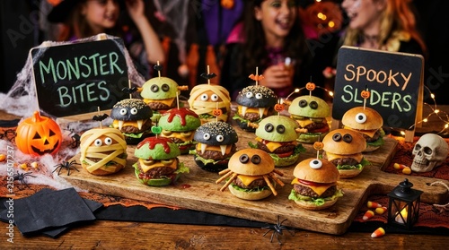 mini burgers creatively decorated as spooky monsters for halloween party
