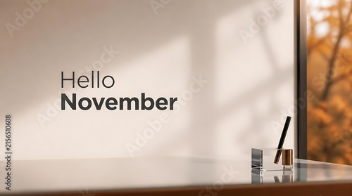 Hello November text on a bright wall with autumn foliage outside.