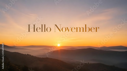 Hello November text overlay on a misty mountain sunrise landscape.