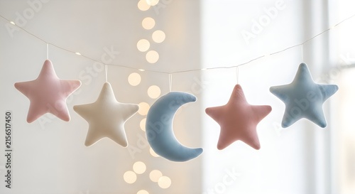 Pastel plush star and moon garland hanging on string with fairy lights on transparent background