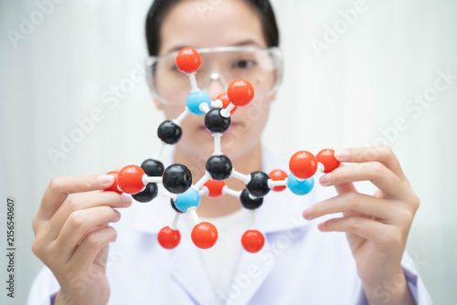 Scientist holding molecular model for chemical technology.
