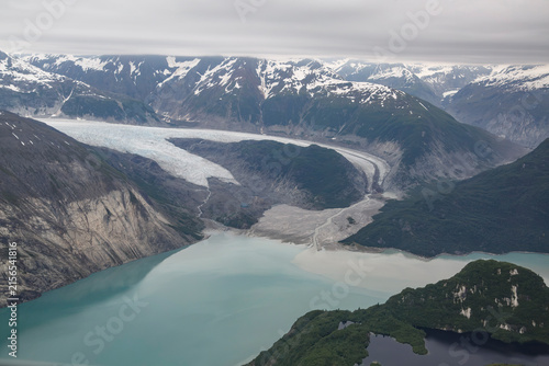 Aerial view of a glacier, lake  snow capped mountains in Glacial Bay