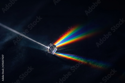 Ein Prisma mit Regenbogenfarben vor schwarzem Hintergrund