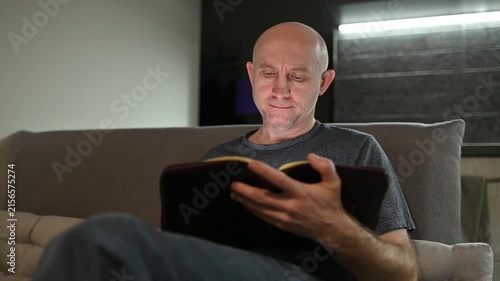 Focused mature man reading and highlighting book pages at Full home video HD
