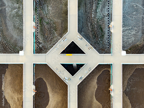 Aerial view of American Fork Wastewater treatment Plant showing aerated bioreactors and settling tanks with textured sludge and water infrastructure in American Fork, Utah, United States.