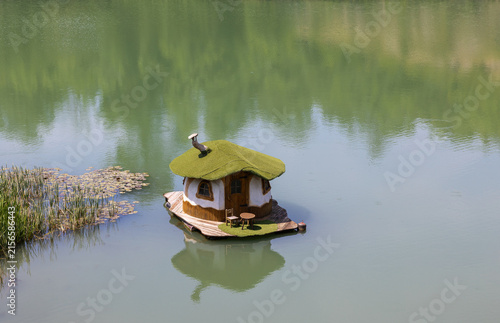 A beautiful landscape: a small house on the shore of a lake in Zlaten Park in Lukovit, Bulgaria