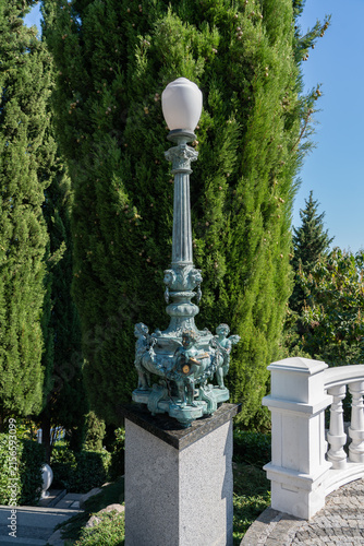 Fotografie Decorative street lamp with intricate sculptures of horses and riders at its base
