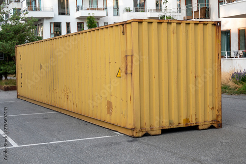 Metal shipping container storage unit container parked on a parking lot at a modern apartment complex