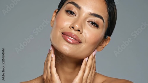 A person gently touches their face with their hands