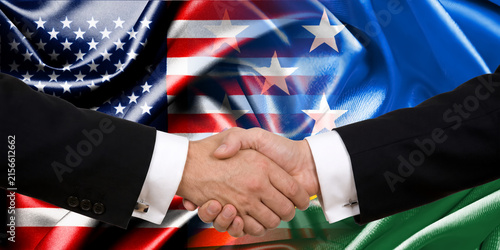 Handshake between the United States and the Solomon Islands, international friendship, background with flags. Flags.
