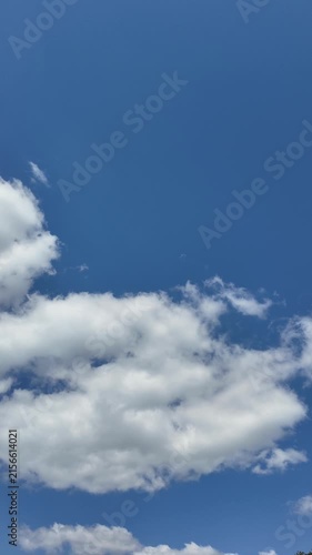 Timelapse of white clouds flying in the blue sky.