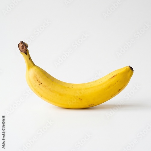 Single ripe yellow banana isolated on white background for healthy food and diet concepts.