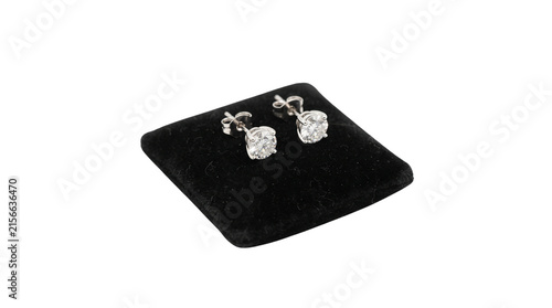 Diamond stud earrings on black velvet cushion, elegant silver jewelry pair, luxury brilliant cut gemstone accessories