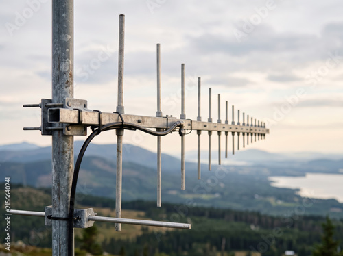 Directional yagi antenna installed on tower overlooking picturesque outdoor landscape background