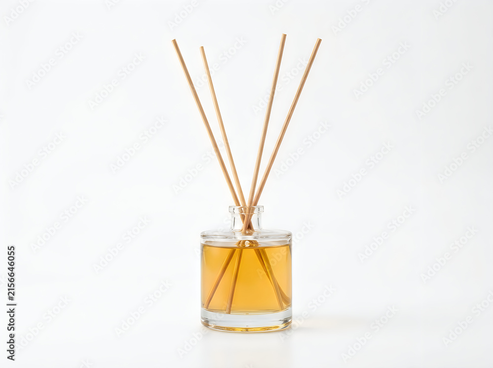 Obraz premium Glass reed diffuser with wooden sticks and aromatic oil isolated on white background