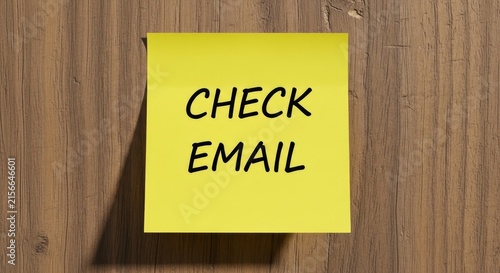 Yellow Sticky Note with Check Email Reminder on Wooden Background.