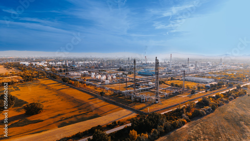 Obraz na płótnie Aerial perspective of oil refining towers and adjacent farmland
