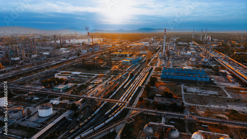 Bild auf Leinwand Aerial view of industrial train tracks and chemical plant equipment