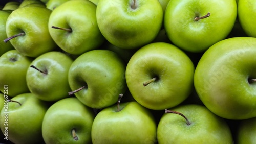 Vibrant Green Apples Stacked in Rows for Healthy Eating and Fresh Produce Marketing Materials