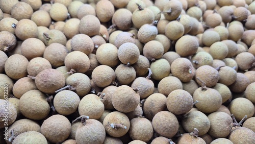 Abundant Pile of Fresh Longan Fruit Displayed for Sale at a Market Stall, Perfect for Healthy Eating and Culinary Projects
