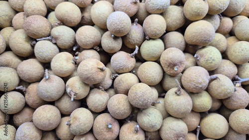 Abundant Fresh Longan Fruit Displayed for Sale at Market Stall, Ideal for Healthy Eating and Exotic Produce Promotion