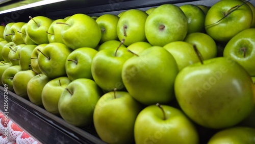 Rows of Fresh Green Granny Smith Apples Displayed in a Supermarket Produce Section for Healthy Eating