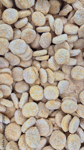 Abundant Pile of Uncooked Breaded Chicken Nuggets Ready for Frying or Baking, Perfect for Food Packaging Design