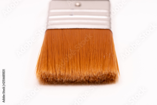 Wide paint brush with orange bristles for painting and decorating