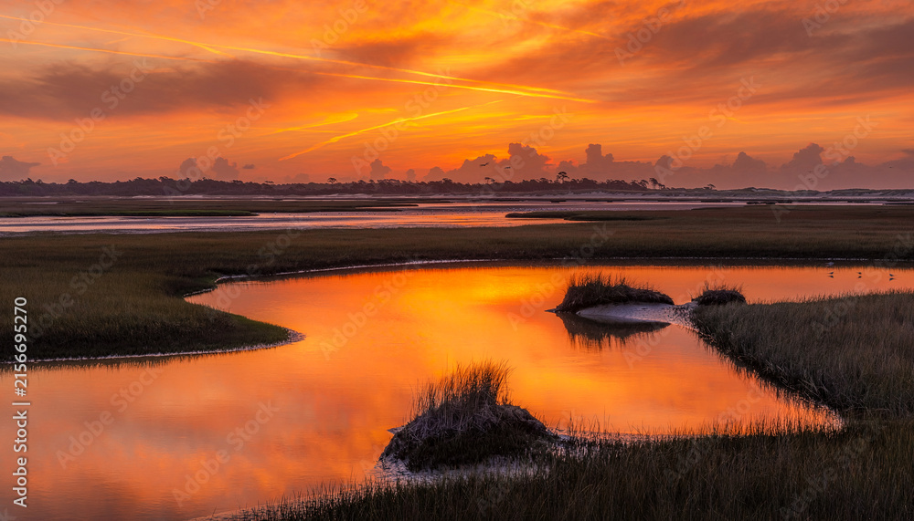 Fototapeta premium Saltwater Marsh Reflecting Dramatic Sunset Sky
