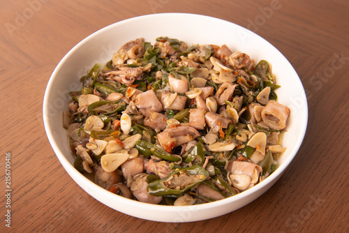 Foto Cumi sambal ijo, or salted squid stir-fried with chopped green chilies and garlic, is a popular home-cooked seafood dish in Indonesia