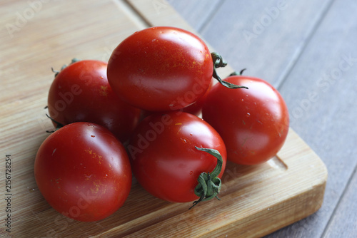 Fresh Red Cherry Tomatoes Stacked on Wooden Cutting Board