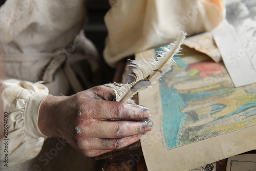 A Mannequin Figure Holding a Vintage Artist Painting Quill.