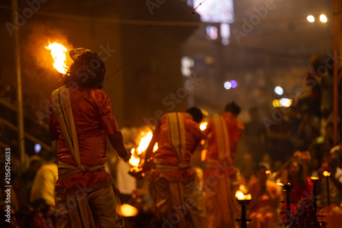 Group of unidentified Hindu priests performs the sacred evening Ganga Aarti ceremony at Assi Ghat in Varanasi. Dressed in traditional attire, the priests conduct the ritual with lamps.