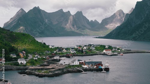 Mountain light falls across a coastal village in the Lofoten Islands, Norway