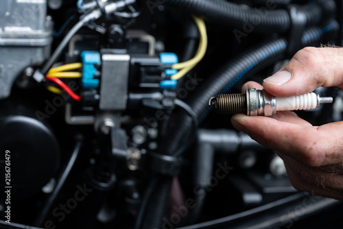 Used Spark Plug Removed from Outboard Engine During Service