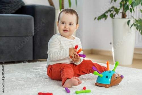 Fotografía Smiling Toddler Playing with Colorful Developmental Toy at Home