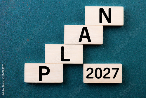 2027 New Year card. New Years goals 2027 with wooden cube, target icon. Concept 2027 New Year background. Goal, plan, action, business, resolutions,  financial, success, ideas