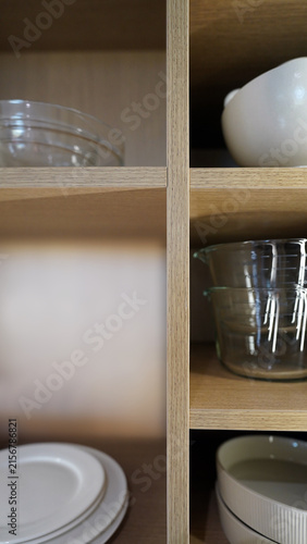 Minimalist Kitchen Interior Featuring Glassware and Plates on Shelves