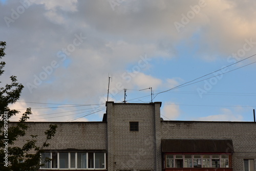 Detail of the facade of a modern apartment building with dark clouds